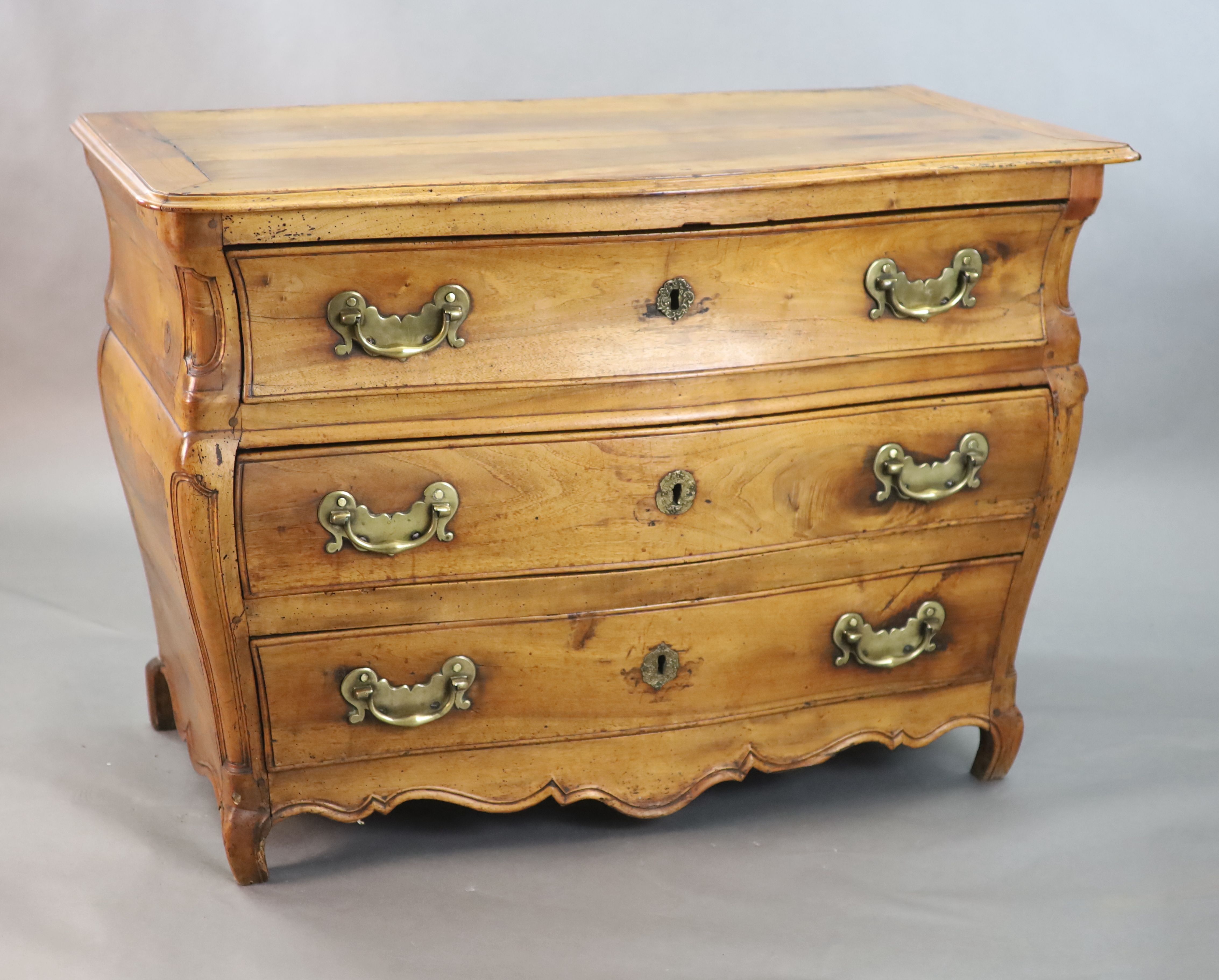 A 19th century Continental walnut serpentine commode, W.3ft 10in. D.2ft 1in. H.2ft 8in.